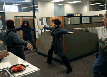 The Administrative Center staff at UMKC taking a break to participate in stretches and yoga together.