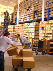 Staff moving a large stack of boxes in the records center.