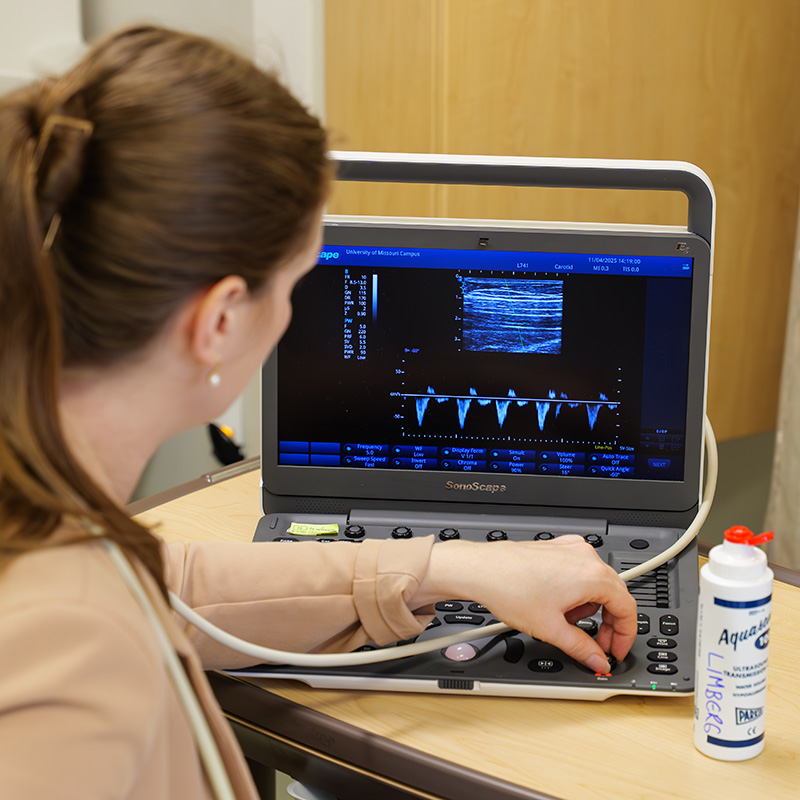 Natasha reviews data on a screen during a clinical study interaction.