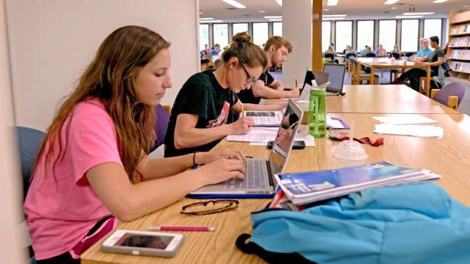 Students studying at a large table