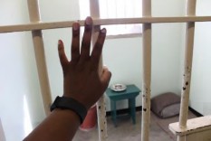 Standing in front of Nelson Mandela's cell