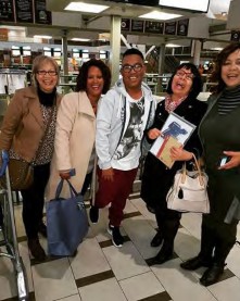 Johan standing with a group of friends and students