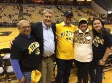 UMSAEP Director Rod Uphoff poses with visiting UWC administrators at an MU basketball game.