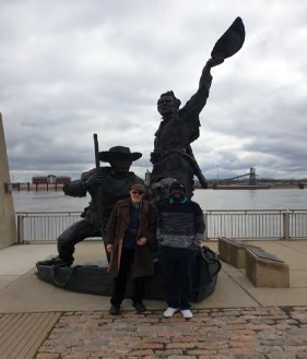 Posing in front of a dynamic statue.