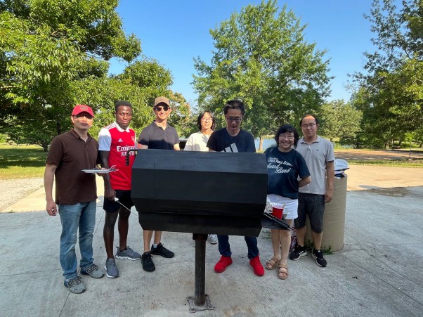 The group enjoying an outdoors cookout