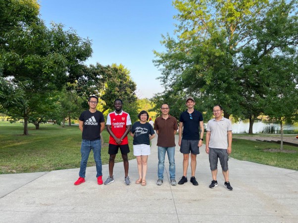 The smaller group posing for a photo outdoors