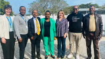 A group of faculty members standing outside