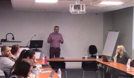 Tokan presenting at a seminar.