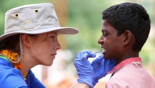 Global First Responder volunteer treats a young boy