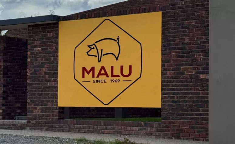 Large entrance sign at the Malu Pork production facility