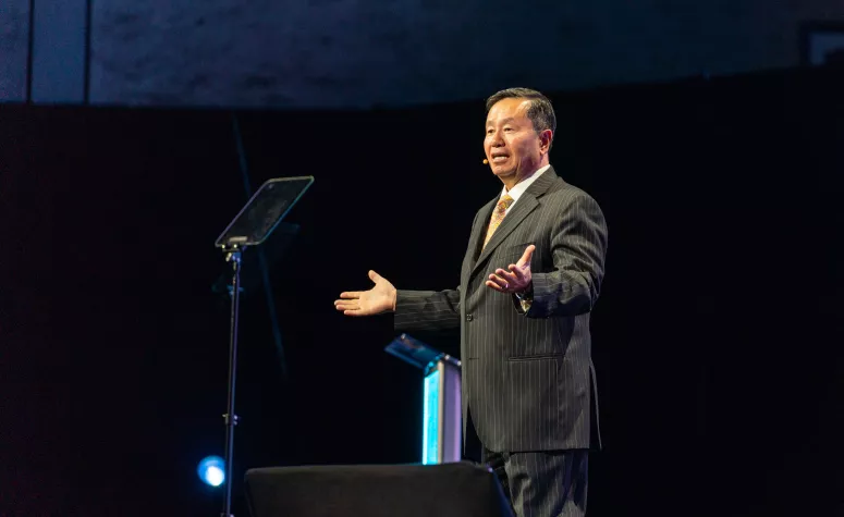 President Choi standing and giving a speech