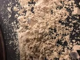 A beige powder on a dark background