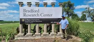 Hussein Shimelis poses with the Bradford Research Center sign