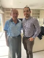 John poses with an interview subject, Justice Richard Goldstone
