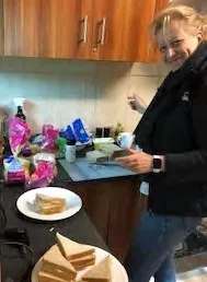 Dr. Bartlett-Esquilant prepares sandwiches at a kitchen counter