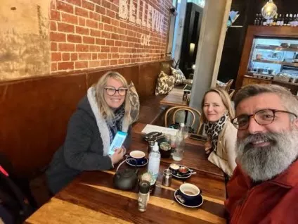 Dr. Jennifer-Anne Chipps, Dr. Petra Brysiewicz and Dr. Tokac sit at a table in a cafe