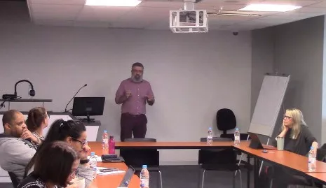 Tokan presenting at a seminar.