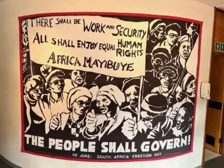 Protest poster that reads "The people shall govern" hangs on the wall in a museum