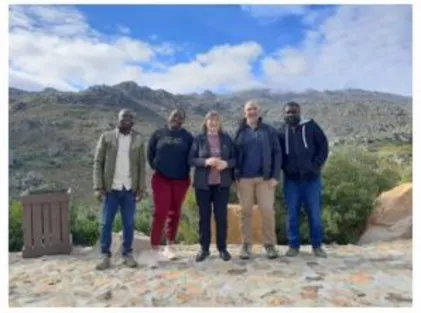 A group of five people pose at the Bree River watershed