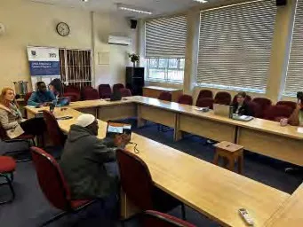 Participating in a group meeting in a conference room