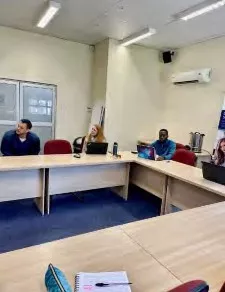 Participating in a group meeting in a conference room
