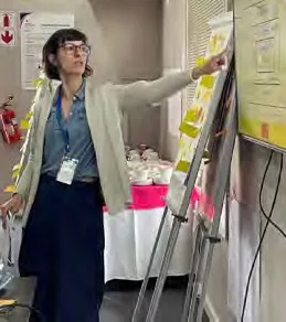 A woman presents information on a board