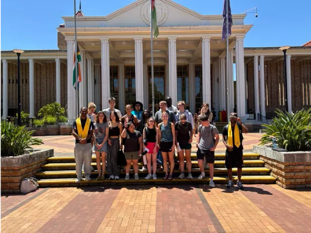 Group of students pose on the steps at UWC