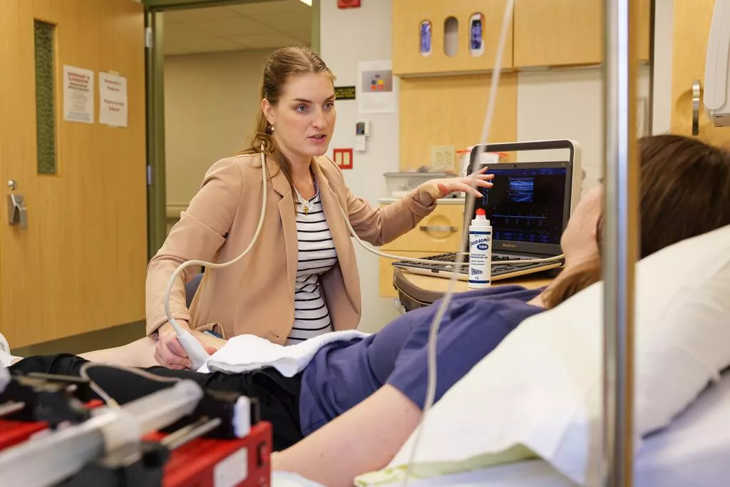 Dr. Boyes explains a study protocol to a research participant in the Clinical Translational Science Unit at University Hospital in Columbia. Photo by Harper Snyder.