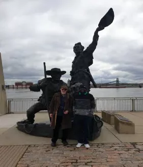 Posing in front of a dynamic statue.