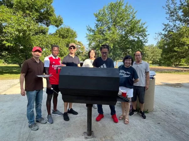 The group enjoying an outdoors cookout