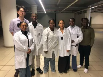 Photo of researchers posing for a photo in a lab
