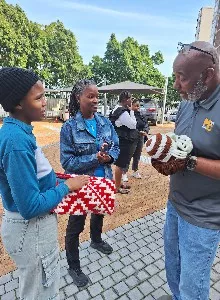 Marvin Carolina, Jr and Michelle Carolina talking to Yonela Mogwaza