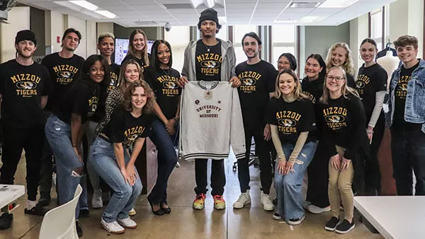 TAM Champion Students holding up sweatshirt