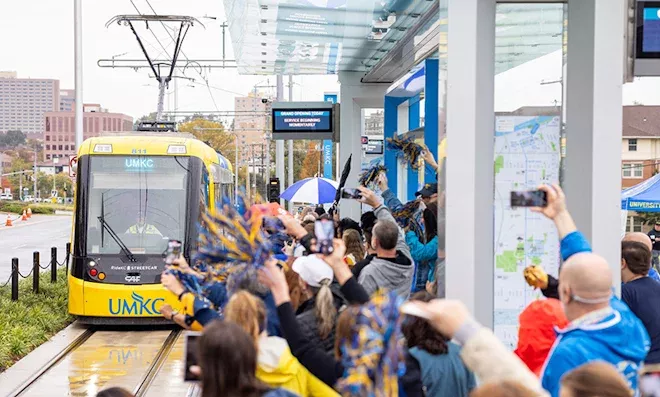 UMKC Streetcar pulling up at the deport in front of a crowd